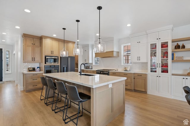 238 W Founders Blvd, Saratoga Springs, UT 84045 - kitchen featuring a sink, gas range oven, black fridge with ice dispenser, stainless steel microwave, and light wood-type flooring
