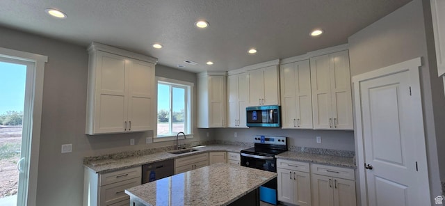 201 W 1300 S Unit 32, Tremonton, UT 84337 - kitchen featuring appliances with stainless steel finishes, a sink, recessed lighting, white cabinetry, and a center island