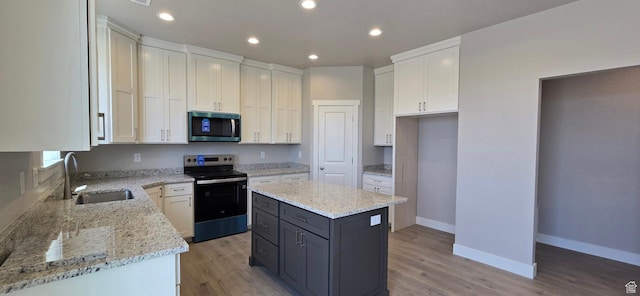 201 W 1300 S Unit 32, Tremonton, UT 84337 - kitchen with stainless steel appliances, a sink, light stone countertops, baseboards, and light wood-type flooring