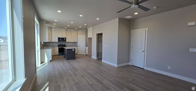 201 W 1300 S Unit 32, Tremonton, UT 84337 - kitchen with stainless steel electric stove, recessed lighting, open floor plan, ceiling fan, and baseboards
