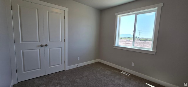 201 W 1300 S Unit 32, Tremonton, UT 84337 - unfurnished bedroom with dark carpet, baseboards, and a closet