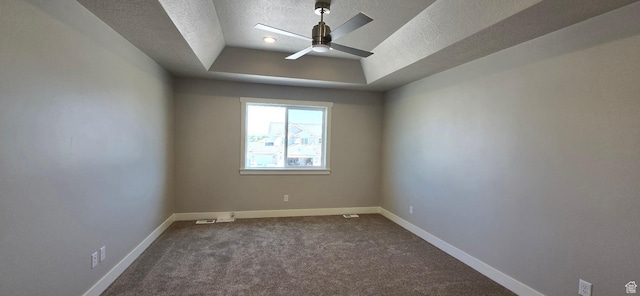 201 W 1300 S Unit 32, Tremonton, UT 84337 - empty room featuring a raised ceiling, a textured ceiling, ceiling fan, dark colored carpet, and baseboards