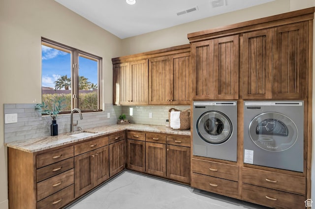 2031 E Cliff Point Dr, St George, UT 84790 - laundry room featuring visible vents, cabinet space, a sink, marble finish floor, and washer and clothes dryer
