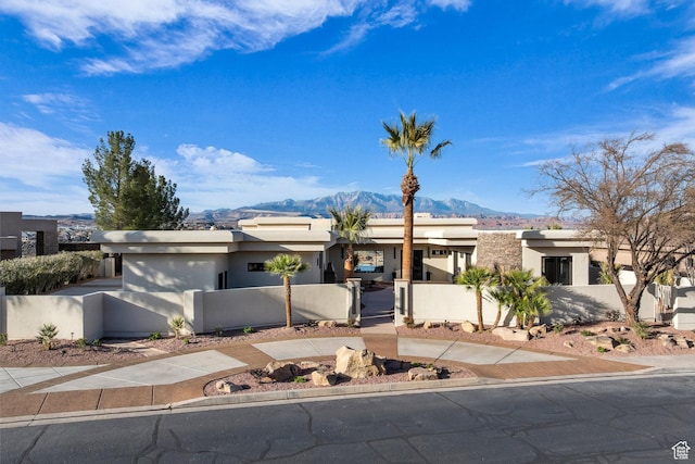 2031 E Cliff Point Dr, St George, UT 84790 - view of front of house with a gate, a fenced front yard, a mountain view, and stucco siding