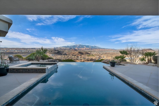 2031 E Cliff Point Dr, St George, UT 84790 - view of pool featuring a patio area, a mountain view, and a pool with connected hot tub