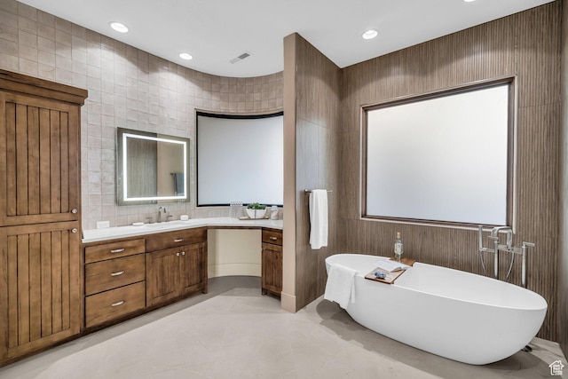 2031 E Cliff Point Dr, St George, UT 84790 - full bath with visible vents, tile walls, recessed lighting, a soaking tub, and vanity