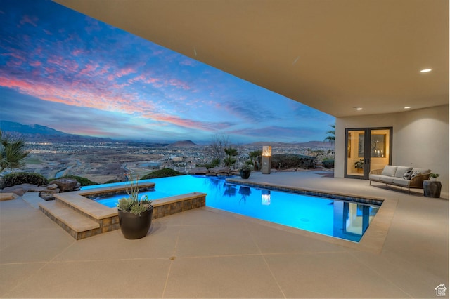 2031 E Cliff Point Dr, St George, UT 84790 - pool at dusk with a patio, a mountain view, and an infinity pool