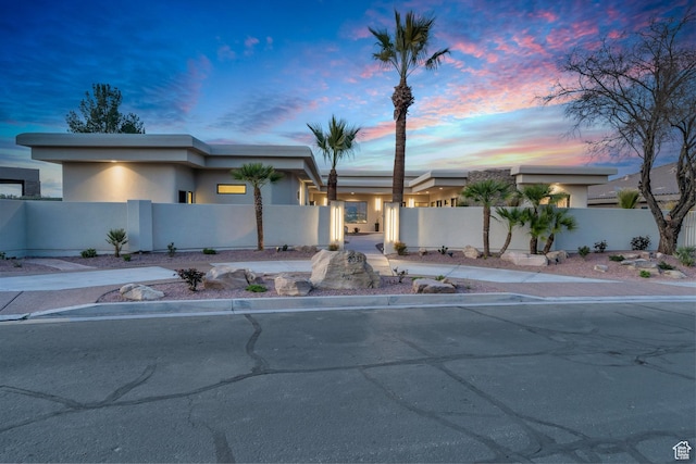 2031 E Cliff Point Dr, St George, UT 84790 - view of front of home featuring a fenced front yard and stucco siding