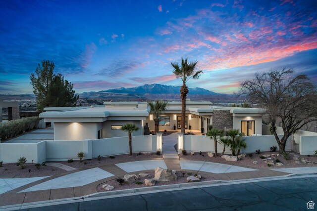 2031 E Cliff Point Dr, St George, UT 84790 - view of front of property with a gate, driveway, stucco siding, a fenced front yard, and a mountain view