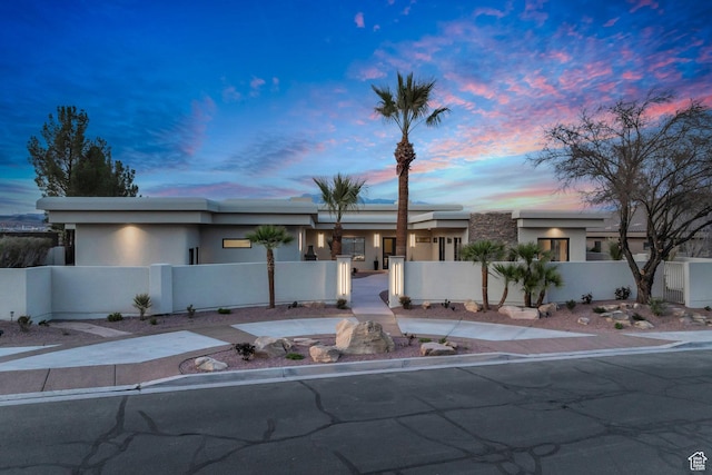 2031 E Cliff Point Dr, St George, UT 84790 - view of front facade featuring a fenced front yard and stucco siding
