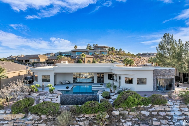 2031 E Cliff Point Dr, St George, UT 84790 - back of property with a patio area, an outdoor pool, and stucco siding