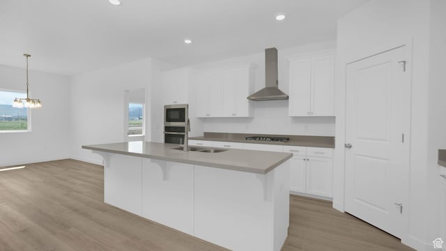 6311 W Butte County Dr S Unit 448, Herriman, UT 84096 - kitchen featuring wall chimney range hood, stainless steel appliances, a sink, white cabinets, and recessed lighting