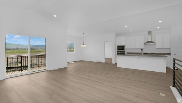 6311 W Butte County Dr S Unit 448, Herriman, UT 84096 - unfurnished living room with recessed lighting, light wood-type flooring, a sink, high vaulted ceiling, and a chandelier