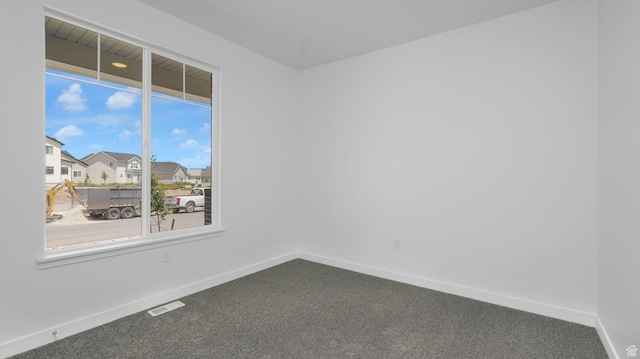 6311 W Butte County Dr S Unit 448, Herriman, UT 84096 - empty room featuring dark carpet, baseboards, and a residential view