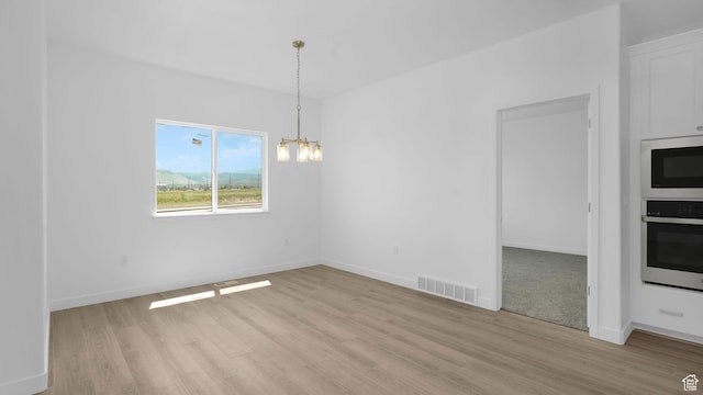 6311 W Butte County Dr S Unit 448, Herriman, UT 84096 - unfurnished dining area with light wood-style flooring, a chandelier, and baseboards