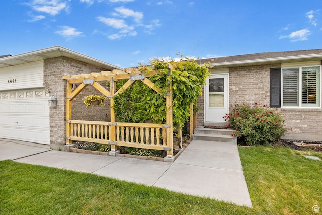 13105 S 2420 W, Riverton, UT 84065 - view of exterior entry with brick siding, an attached garage, and a yard