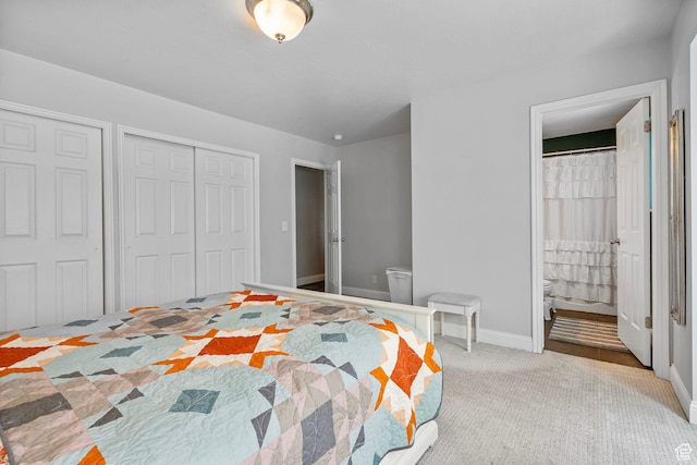 13105 S 2420 W, Riverton, UT 84065 - bedroom featuring baseboards, connected bathroom, carpet flooring, and two closets