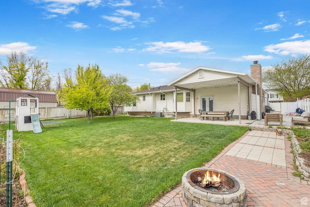 13105 S 2420 W, Riverton, UT 84065 - rear view of house with a fire pit, a patio, and a chimney