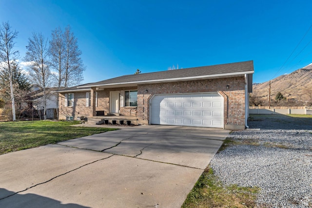 77 E 1100 N, Pleasant Grove, UT 84062 - single story home with driveway, a mountain view, a front yard, a garage, and brick siding