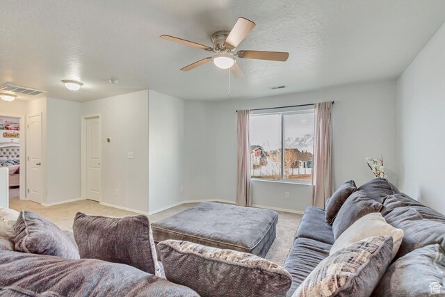 932 Jasper Cir, Tooele, UT 84074 - living room with light carpet, visible vents, baseboards, and ceiling fan