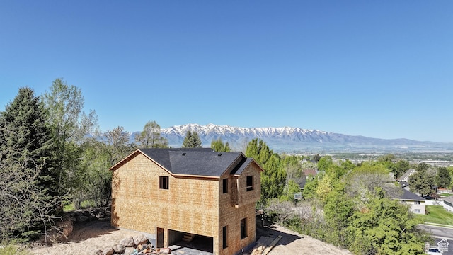 615 Dover Cir, Providence, UT 84332 - view of side of property featuring a shingled roof and a mountain view