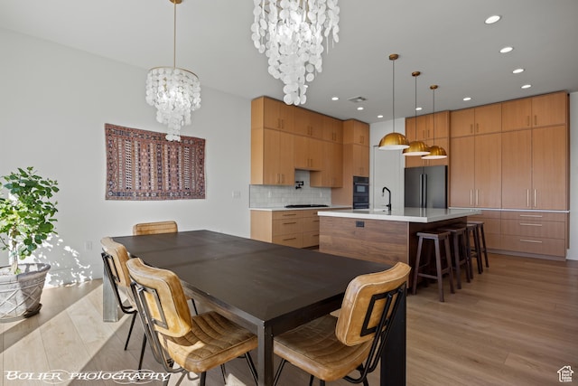 3218 E Rimrunner Dr, St George, UT 84790 - dining room with recessed lighting, light wood-type flooring, an inviting chandelier, and visible vents