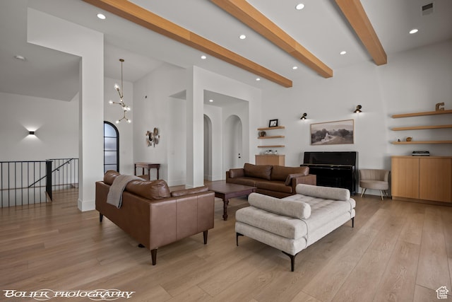 3218 E Rimrunner Dr, St George, UT 84790 - living room with light wood finished floors, a high ceiling, recessed lighting, arched walkways, and beamed ceiling