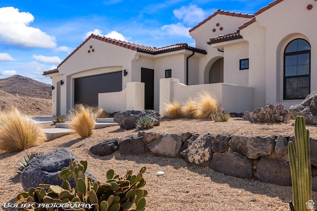 3218 E Rimrunner Dr, St George, UT 84790 - mediterranean / spanish-style house with stucco siding, a tile roof, and a garage
