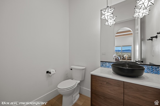 3218 E Rimrunner Dr, St George, UT 84790 - bathroom with baseboards, toilet, and vanity