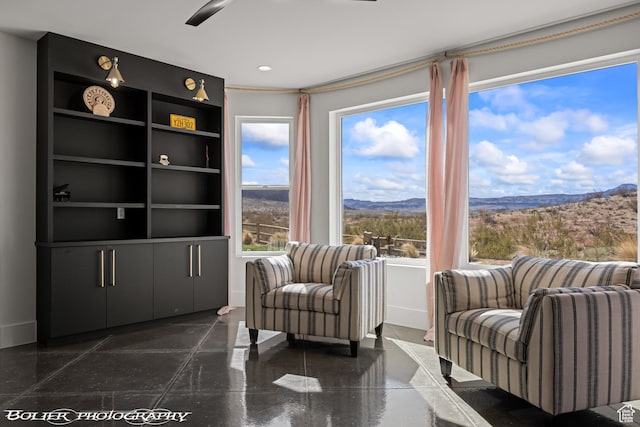 3218 E Rimrunner Dr, St George, UT 84790 - sitting room with a mountain view, baseboards, and ceiling fan