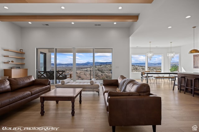 3218 E Rimrunner Dr, St George, UT 84790 - living area featuring visible vents, wood finished floors, recessed lighting, a mountain view, and an inviting chandelier