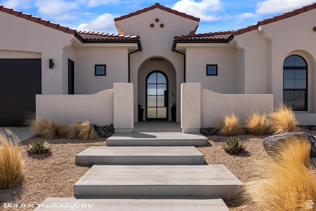 3218 E Rimrunner Dr, St George, UT 84790 - view of front of property with stucco siding, an attached garage, and a tile roof