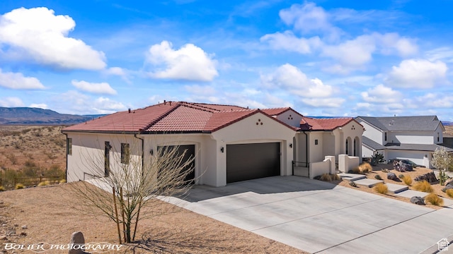 3218 E Rimrunner Dr, St George, UT 84790 - mediterranean / spanish home with stucco siding, a tile roof, a mountain view, concrete driveway, and an attached garage
