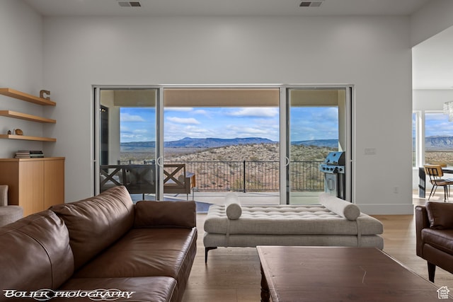 3218 E Rimrunner Dr, St George, UT 84790 - living area with a mountain view, baseboards, light wood-style floors, and visible vents