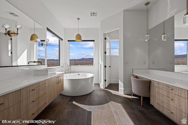 3218 E Rimrunner Dr, St George, UT 84790 - bathroom featuring a freestanding tub, visible vents, and vanity