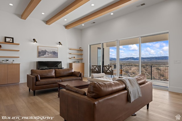 3218 E Rimrunner Dr, St George, UT 84790 - living room with a mountain view, beamed ceiling, visible vents, and light wood-type flooring