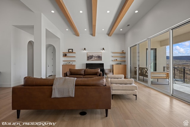 3218 E Rimrunner Dr, St George, UT 84790 - living room featuring baseboards, beam ceiling, recessed lighting, light wood-style floors, and arched walkways