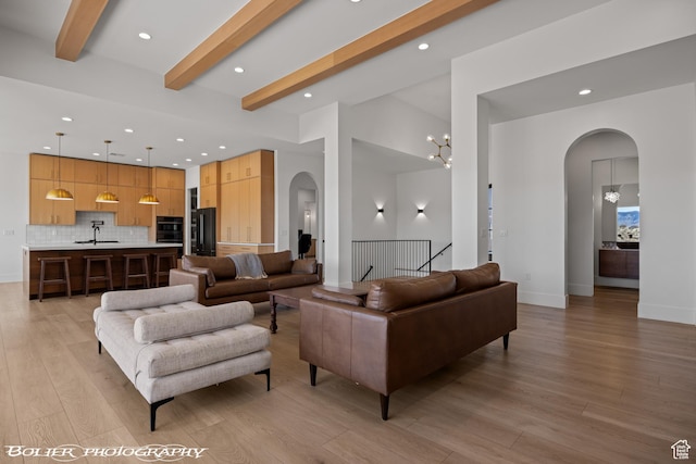 3218 E Rimrunner Dr, St George, UT 84790 - living area with arched walkways, beamed ceiling, recessed lighting, and light wood finished floors