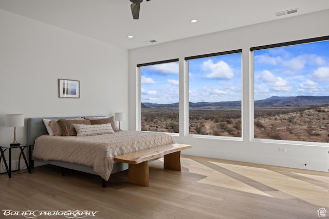 3218 E Rimrunner Dr, St George, UT 84790 - bedroom featuring light wood-style flooring, visible vents, and a mountain view