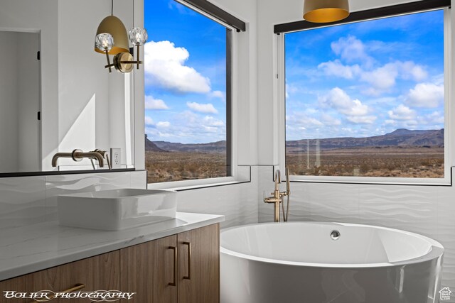 3218 E Rimrunner Dr, St George, UT 84790 - bathroom featuring a freestanding tub, a mountain view, and vanity