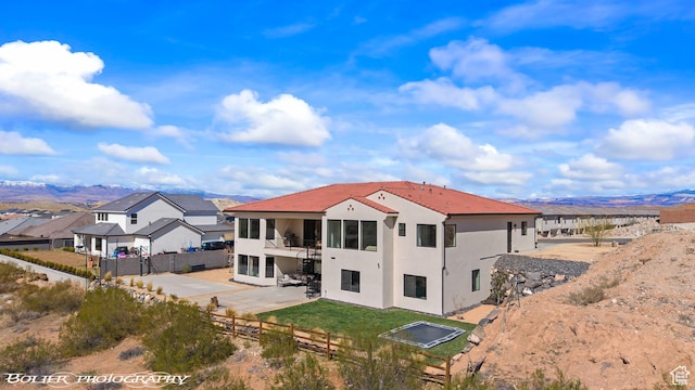 3218 E Rimrunner Dr, St George, UT 84790 - rear view of house featuring a tiled roof, stucco siding, a lawn, a fenced backyard, and a patio