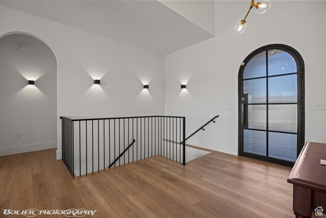 3218 E Rimrunner Dr, St George, UT 84790 - stairs with wood finished floors, baseboards, and arched walkways