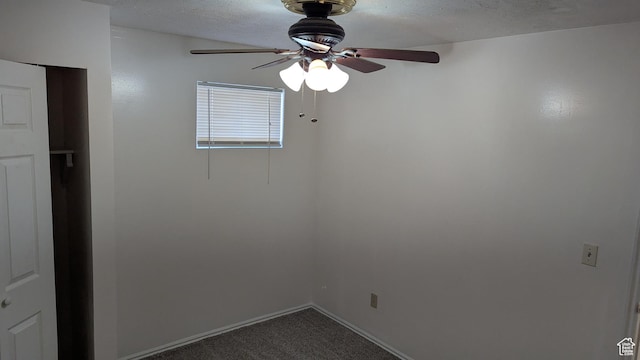 5063 S 2825 W, Roy, UT 84067 - spare room featuring baseboards, dark colored carpet, a textured ceiling, and ceiling fan