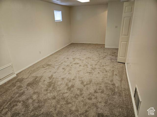 5063 S 2825 W, Roy, UT 84067 - basement featuring baseboards, visible vents, and carpet