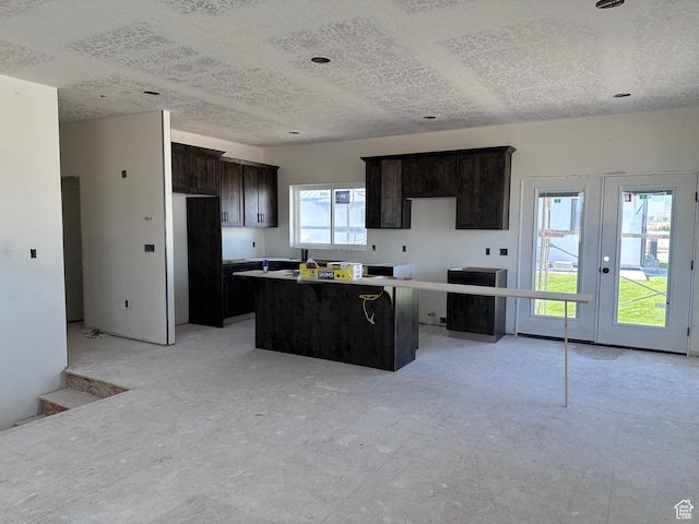 265 W 400 S, Ephraim, UT 84627 - kitchen with a center island, a textured ceiling, french doors, and dark brown cabinets