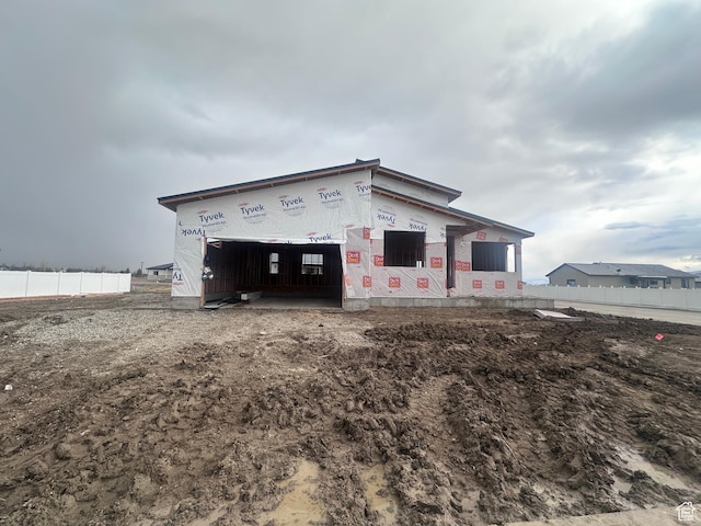 view of outbuilding featuring fence
