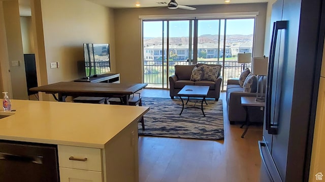 living room featuring ceiling fan and wood finished floors