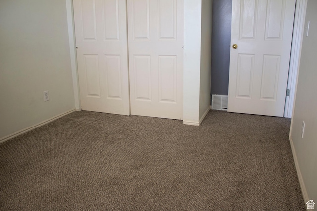 246 W 5000 S, Washington Terrace, UT 84405 - unfurnished bedroom with a closet, baseboards, visible vents, and dark carpet