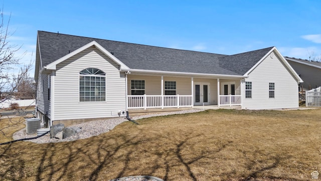 back of property with cooling unit, a porch, a shingled roof, french doors, and a lawn
