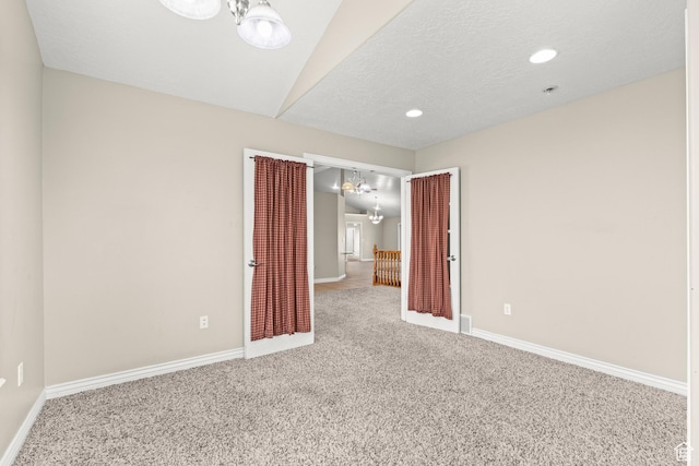 spare room featuring carpet, baseboards, recessed lighting, a textured ceiling, and a chandelier